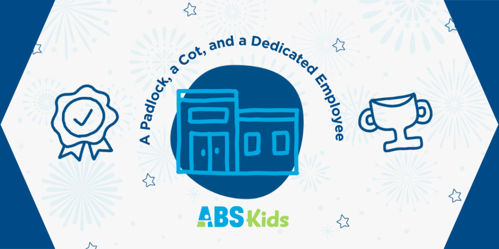 Illustration featuring a padlock, a cot, and a building with the text 'A Padlock, a Cot, and a Dedicated Employee' above. The ABS Kids logo is displayed at the bottom. The background has fireworks and stars, highlighting the theme of dedication and hard work.