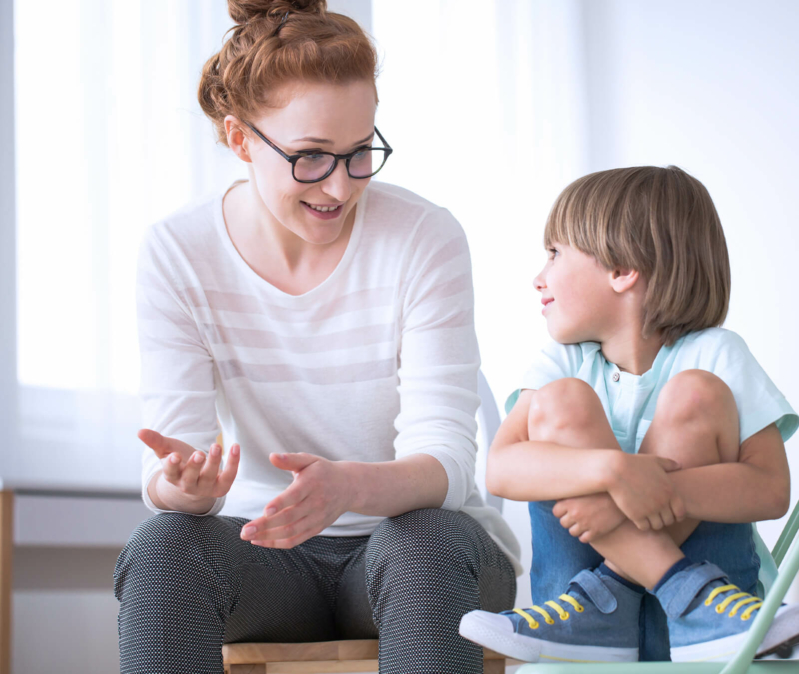 Woman talking with a child during autism diagnosis